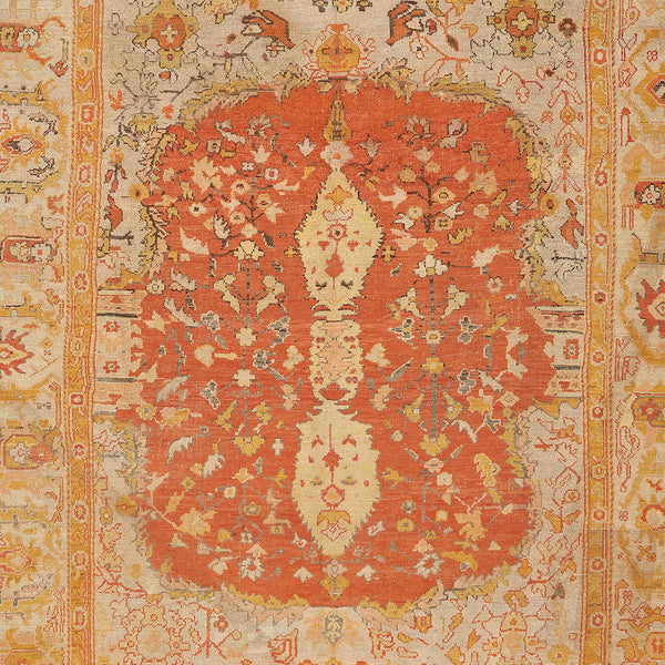 Intricate, ornate Persian rug with floral motifs and aged patina.