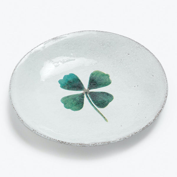 Handcrafted ceramic dish with rustic charm features a lucky four-leaf clover.