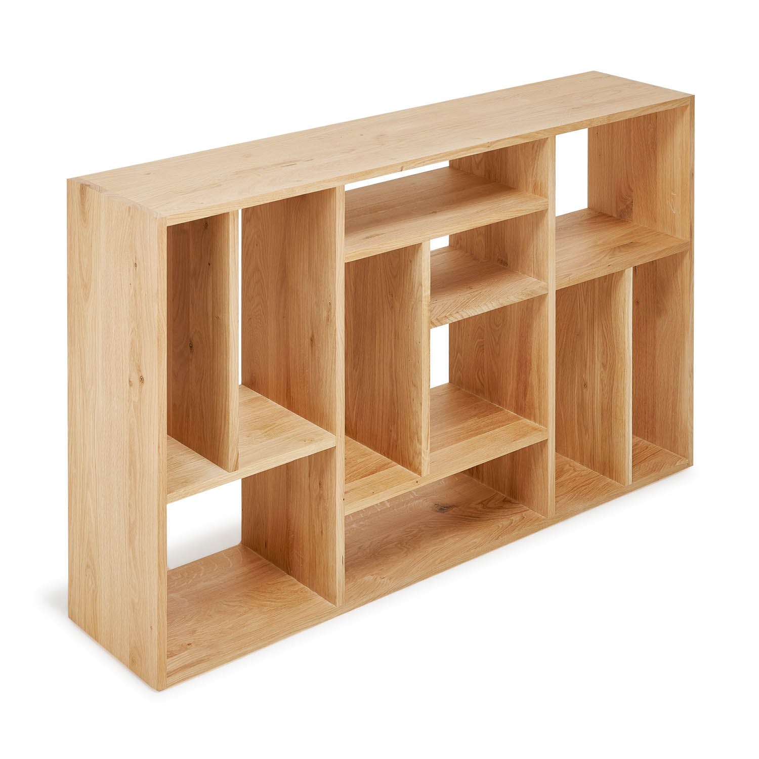 Modern wooden shelving unit with varying compartments on white background.