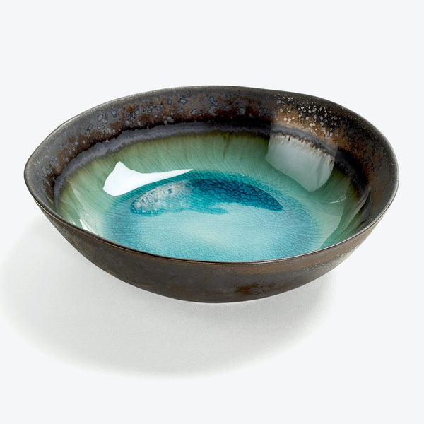 Artisan-crafted ceramic bowl with a stunning gradient of blue hues.