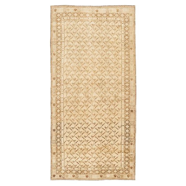 Rectangular rug with intricate geometric and floral motifs in neutral tones.