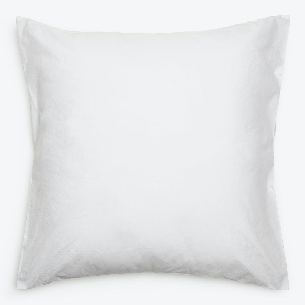 Plain white pillow with a smooth surface and rounded edges.