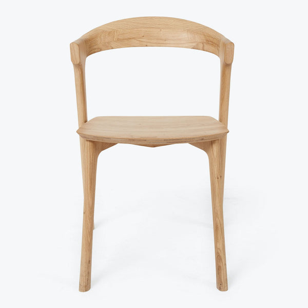 Minimalist wooden chair with sleek design and natural wood finish.