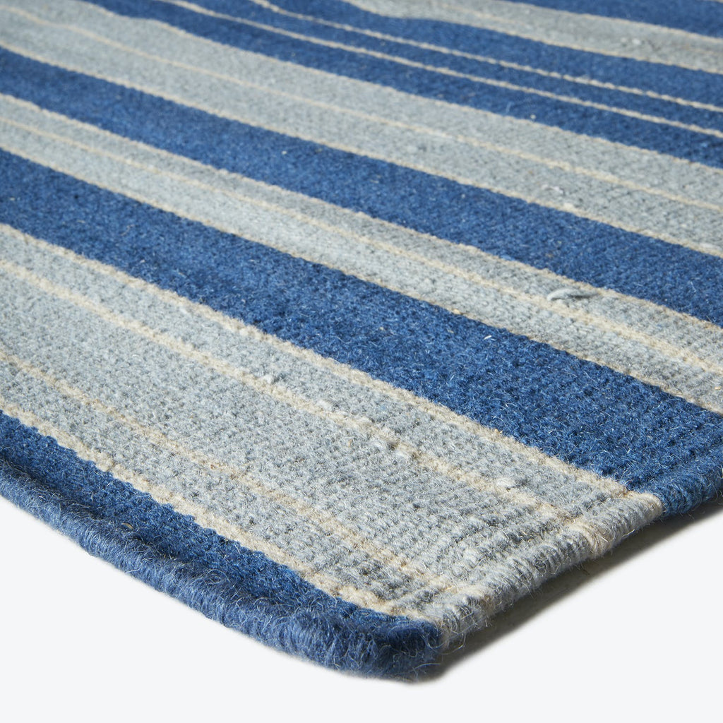 Close-up of a knitted striped fabric with blue and gray bands