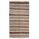 Horizontal striped rug with natural colors adds warmth and texture.