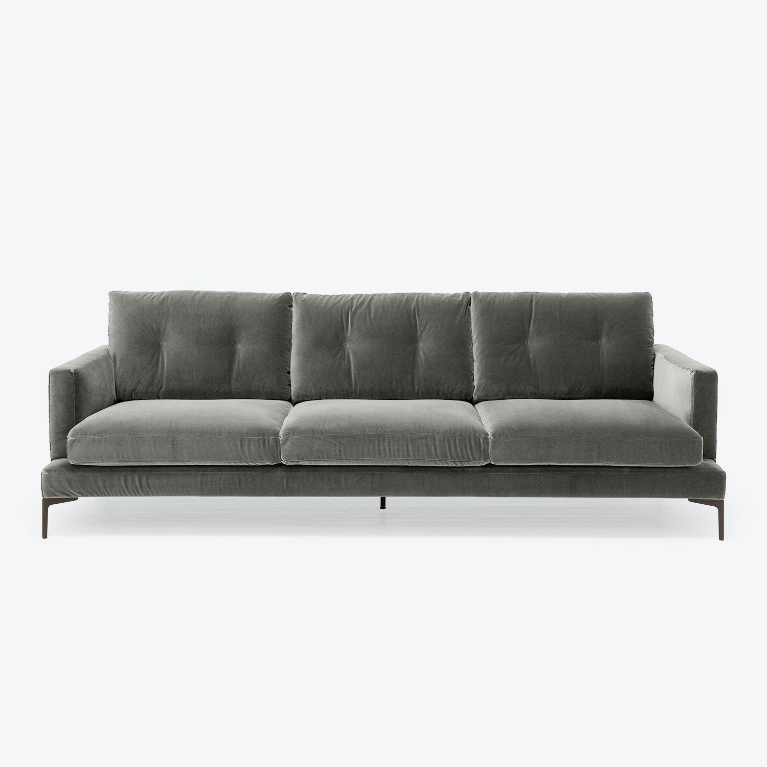 Minimalist modern sofa with plush velvet upholstery in dark tones.