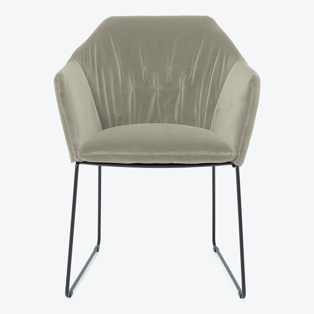 Contemporary armchair with sage green velvet upholstery and sleek metal legs.