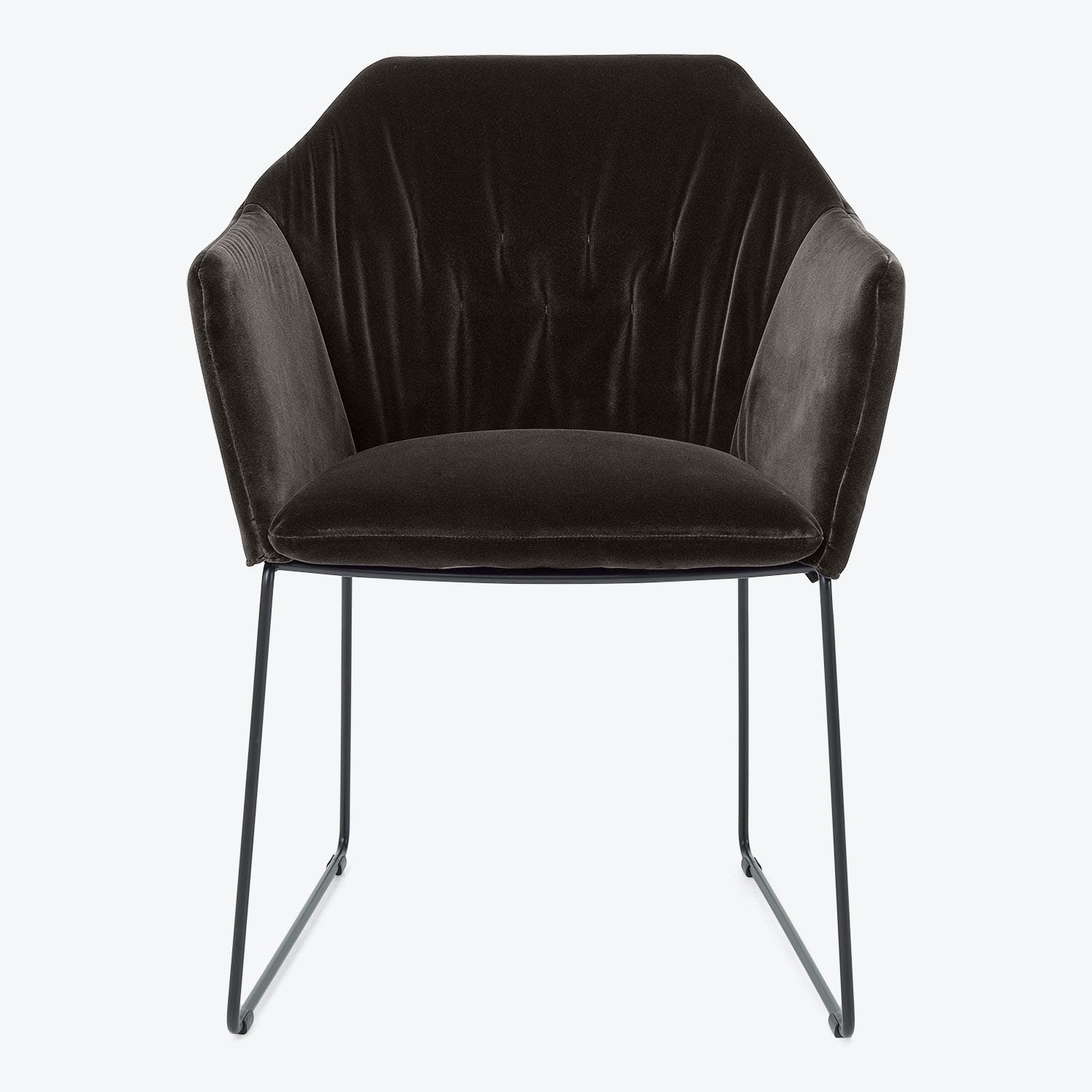 Contemporary black velvet armchair with tufted design and minimalist frame