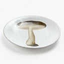 Handmade, textured white plate with a stylized mushroom design.