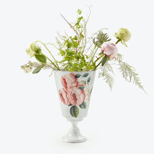 A beautiful arrangement of assorted flowers and plants in a classical vase.