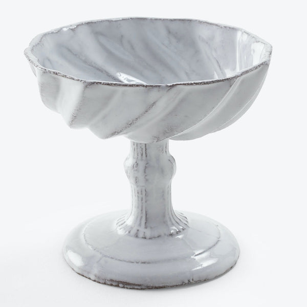 An elegant footed bowl with a marbled ceramic finish.