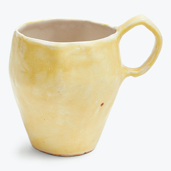 Handcrafted mug with a unique shape and rustic yellow glaze.