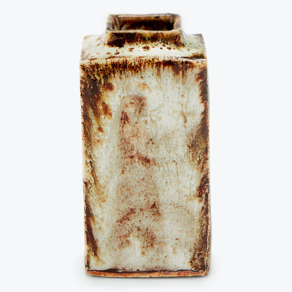 An old, heavily rusted rectangular metal can with crimped edges.
