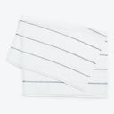 White terrycloth hand towels with textured stripes and metallic accents.