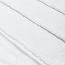 Close-up view of white terry cloth fabric with diagonal stitching.