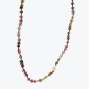 Colorful beaded necklace on white background showcases bohemian style.