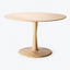 A minimalist round wooden table with an elegant, beveled design.