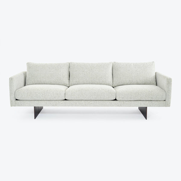 Contemporary minimalist sofa with clean lines and metal legs.