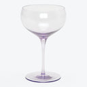 Empty red wine glass with elegant design against white background.