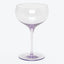 Empty red wine glass with elegant design against white background.