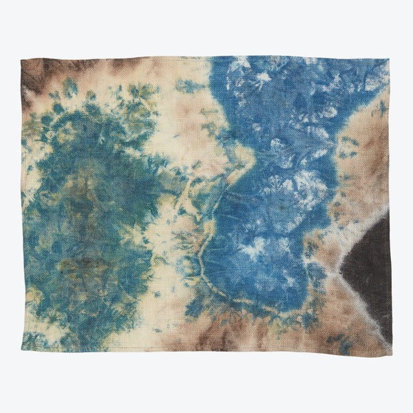 Rectangular tie-dye fabric showcasing a mix of blue and brown hues with hints of green and black.