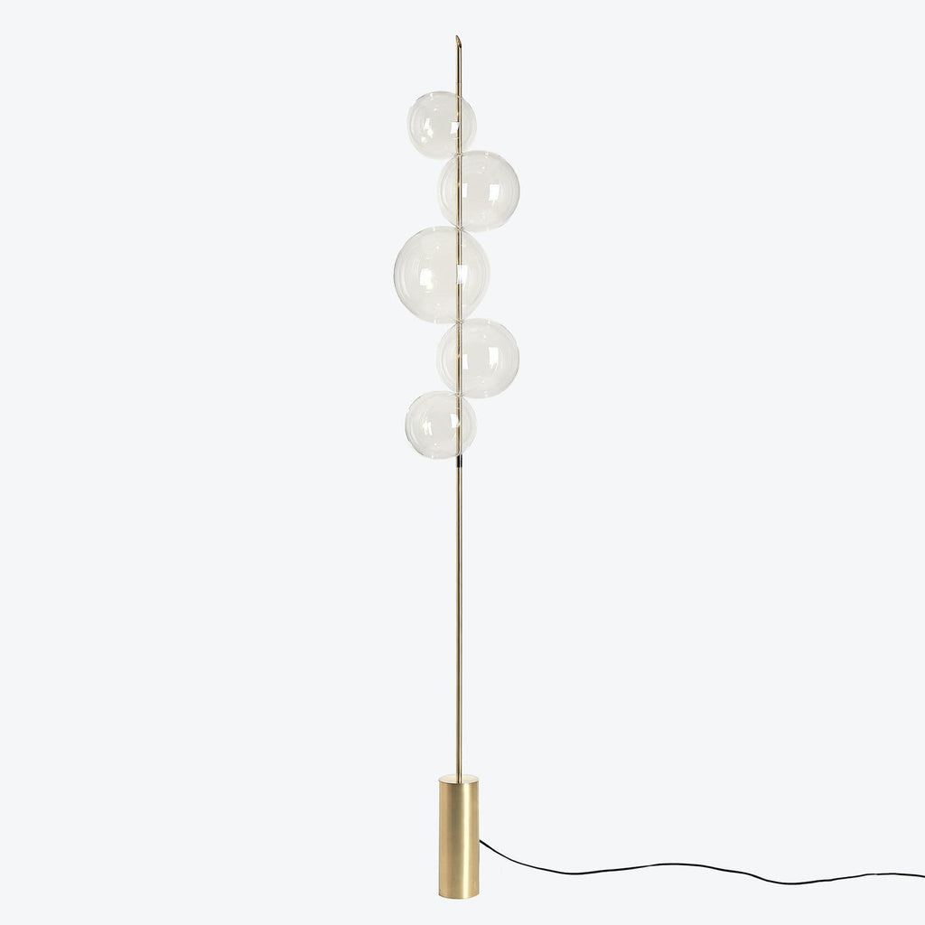 Modern floor lamp with gold finish and spherical glass globes.