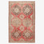 An ornate handwoven rug showcasing rich red tones and intricate patterns.