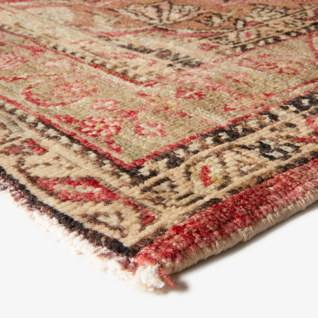 Close-up of a hand-knotted Oriental rug with intricate design.