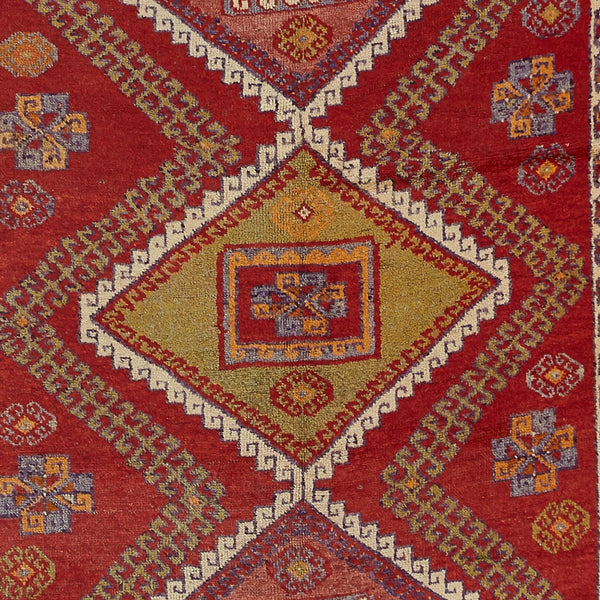 Traditional handcrafted rug showcases intricate pattern with rich colors and symmetrical design.