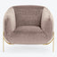 Modern-style armchair with a plush, blush velvety upholstery and sleek metallic legs.