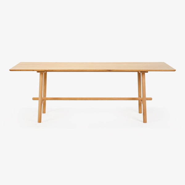 Minimalistic wooden table with a contemporary design on white background.