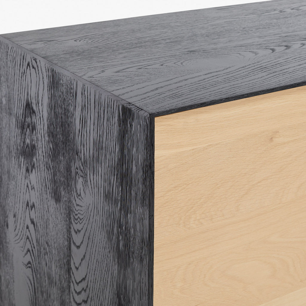 Close-up of modern, minimalist cabinet with striking wood grain contrast.