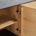 Close-up of a high-quality wooden cabinet with brass hinges.