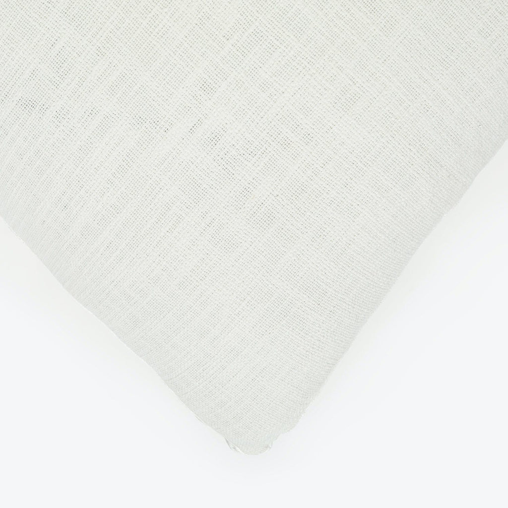 Close-up of white textile with visible weave pattern and texture.
