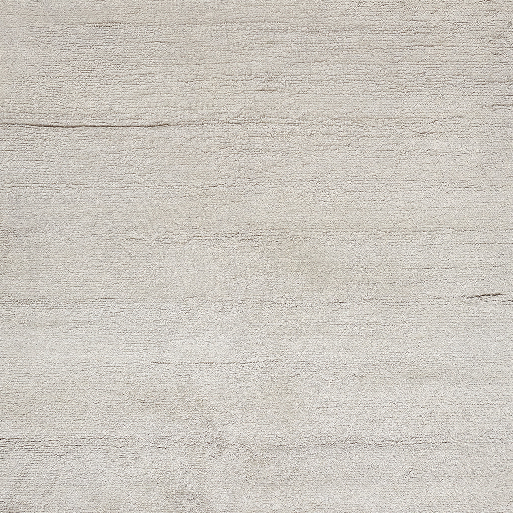 Neutral textured surface resembling a pale concrete wall with horizontal lines.