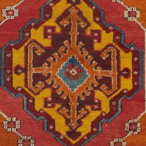 Close-up of a symmetrical and ornate traditional rug design.