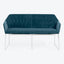 Contemporary blue velvet sofa with sleek design and plush cushions.