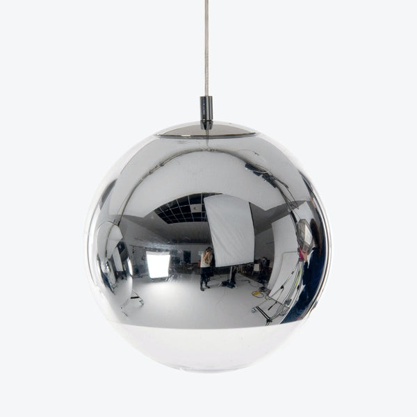Highly reflective chrome pendant light reflecting photography studio environment.