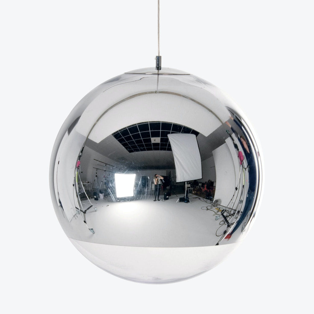 Reflective sphere captures creative atmosphere in photography/film studio setting.