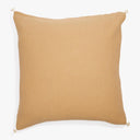 Square beige cushion with textured fabric and decorative tassels.