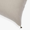 Close-up of textured cushion with black tassel adds subtle detail.