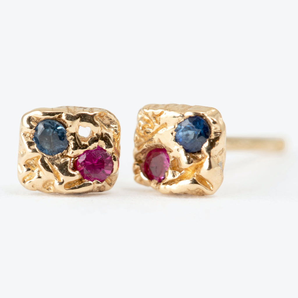 Artisan gold-toned stud earrings with textured surfaces, gemstone accents