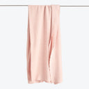 Soft pink fabric hangs freely, offering a serene and minimalist look.