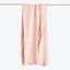Soft pink fabric hangs freely, offering a serene and minimalist look.