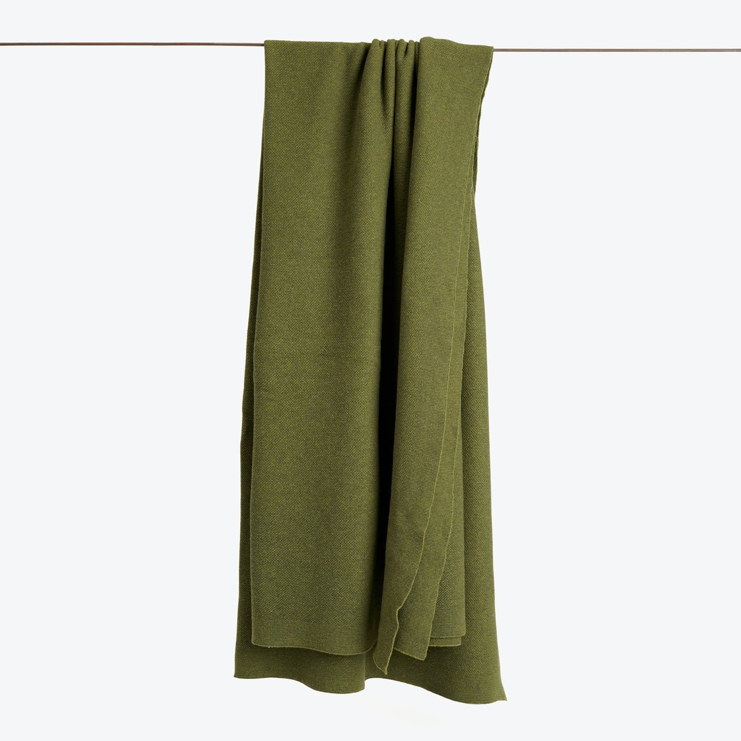Green fabric drapes effortlessly, creating a serene visual effect.
