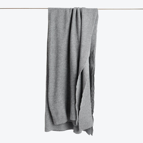 Soft and rumpled gray fabric hangs against neutral background.