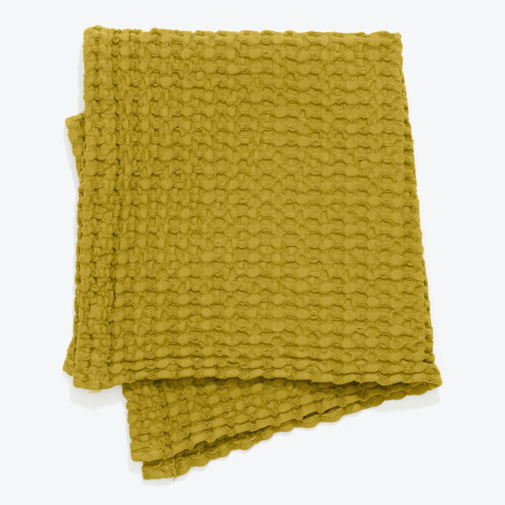 Soft and textured olive yellow blanket with scalloped edges
