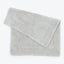 Soft and durable light gray bath towel with stitched border.