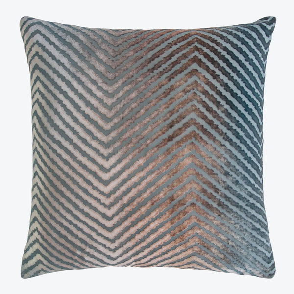 Decorative chevron-patterned pillow in blues, grays, and browns on white background.
