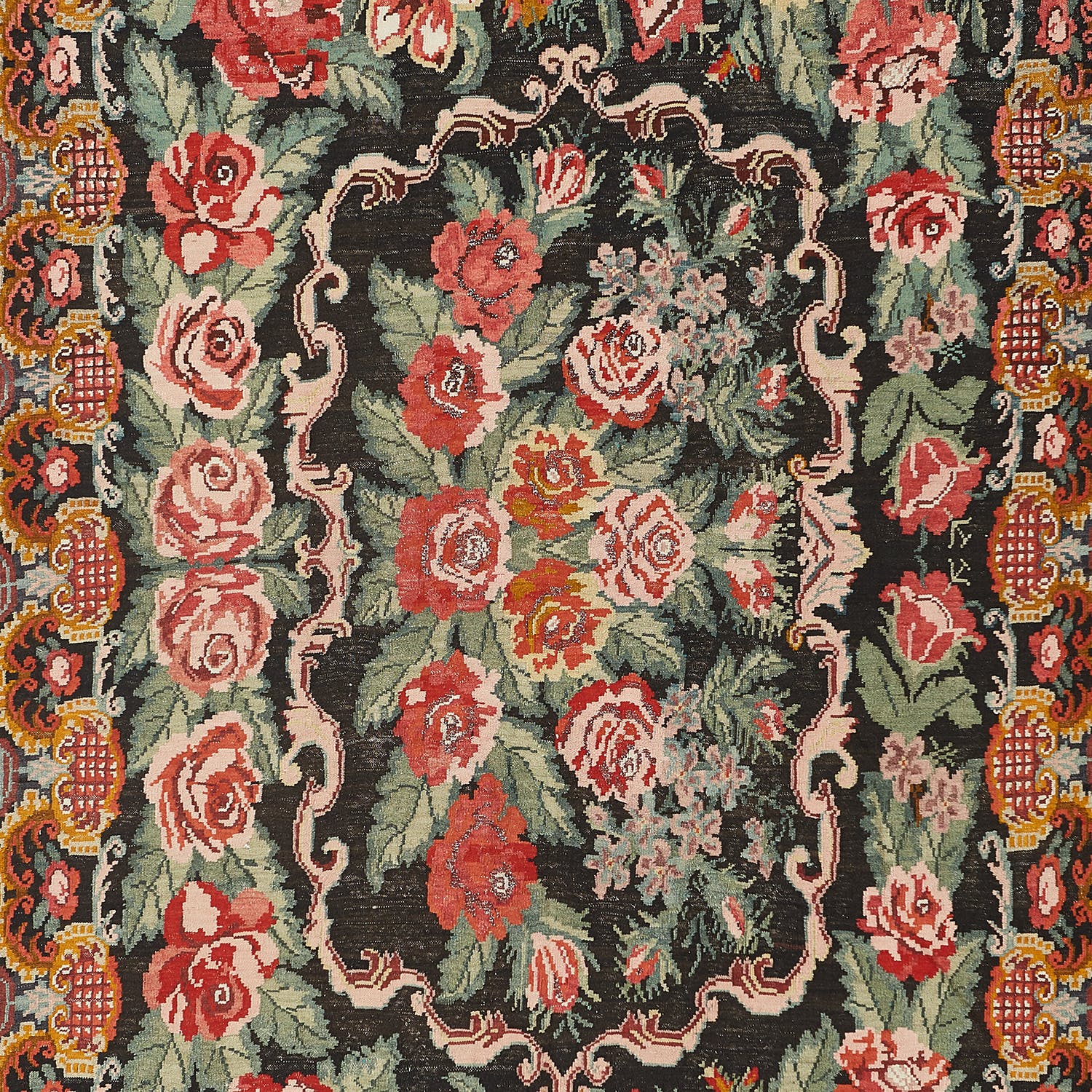 Hand-crafted rug with intricate floral pattern in shades of red